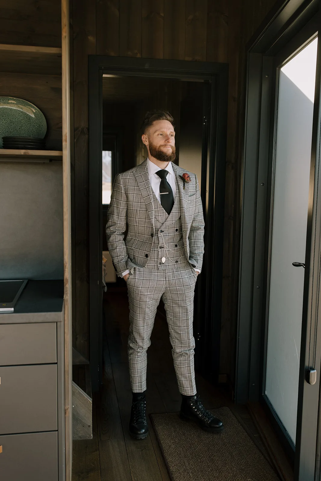 Trendy Groom in a Checkered Suit, in the hotel getting ready.