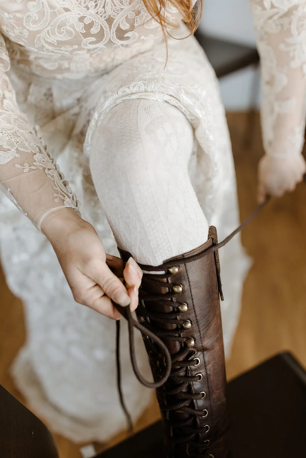 A bride laces up her boots on her Iceland Destination Wedding.