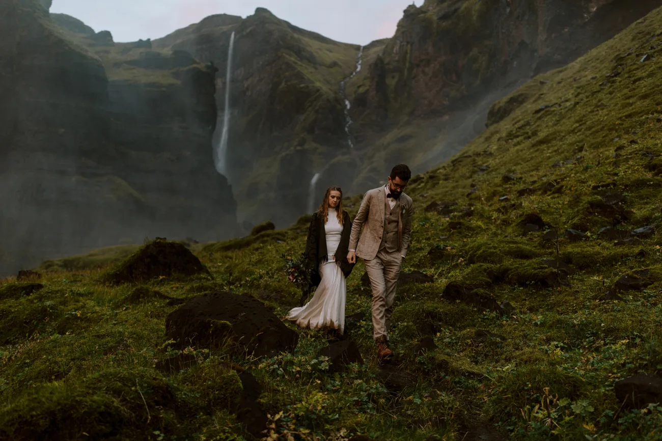 Bride and groom hiking, tired after a long a eventful Icelandic elopement