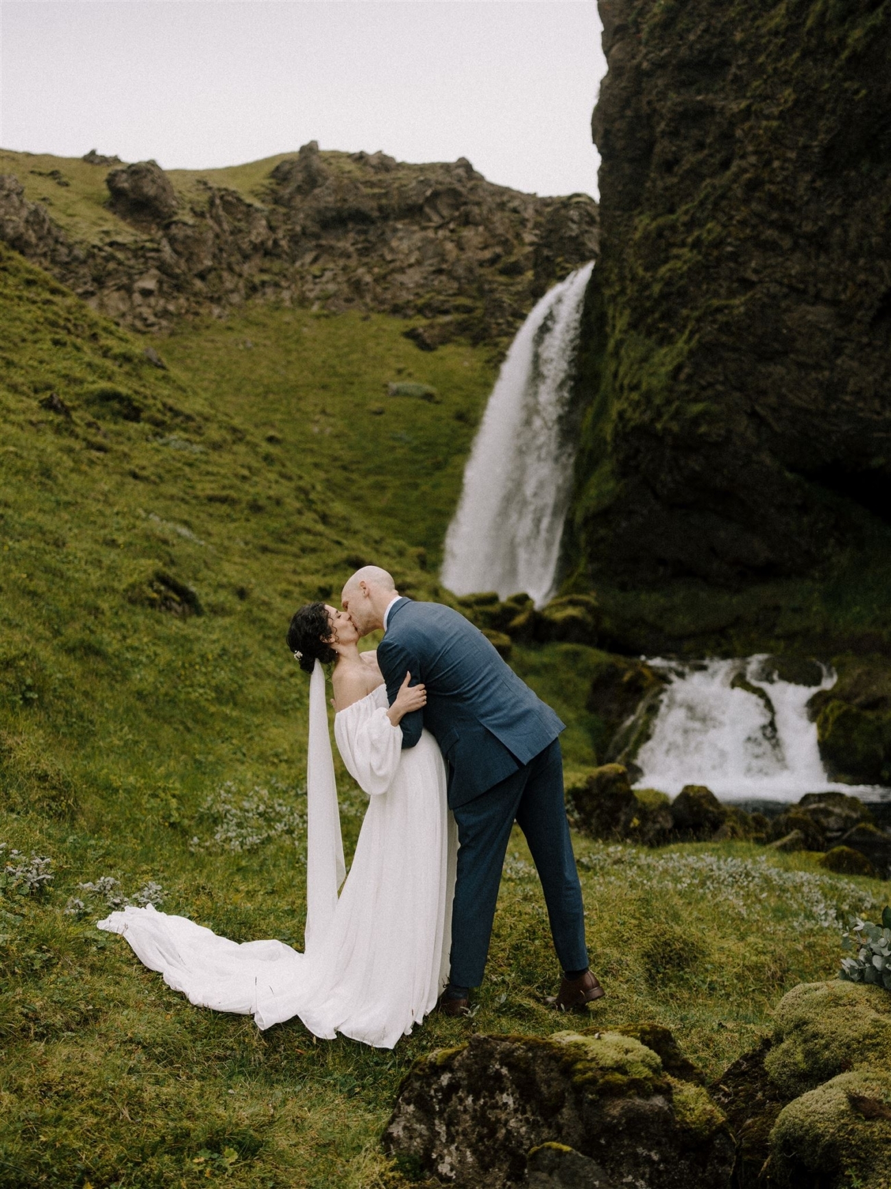 A dramatic ceremony kiss in the wilds of Iceland during an elopement day.