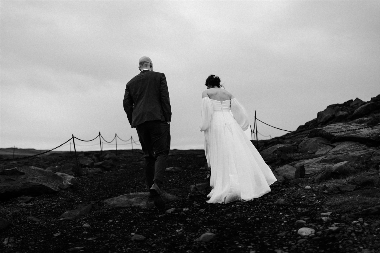 Hiking on the black sand beaches of Iceland's south coast during an elopement day.