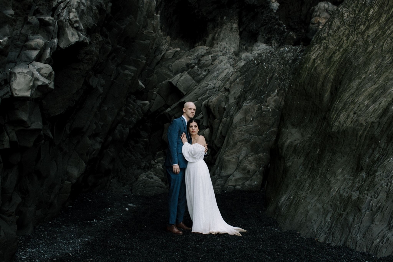 A bride and groom portrait on the black sand beach of Reynisfjara.