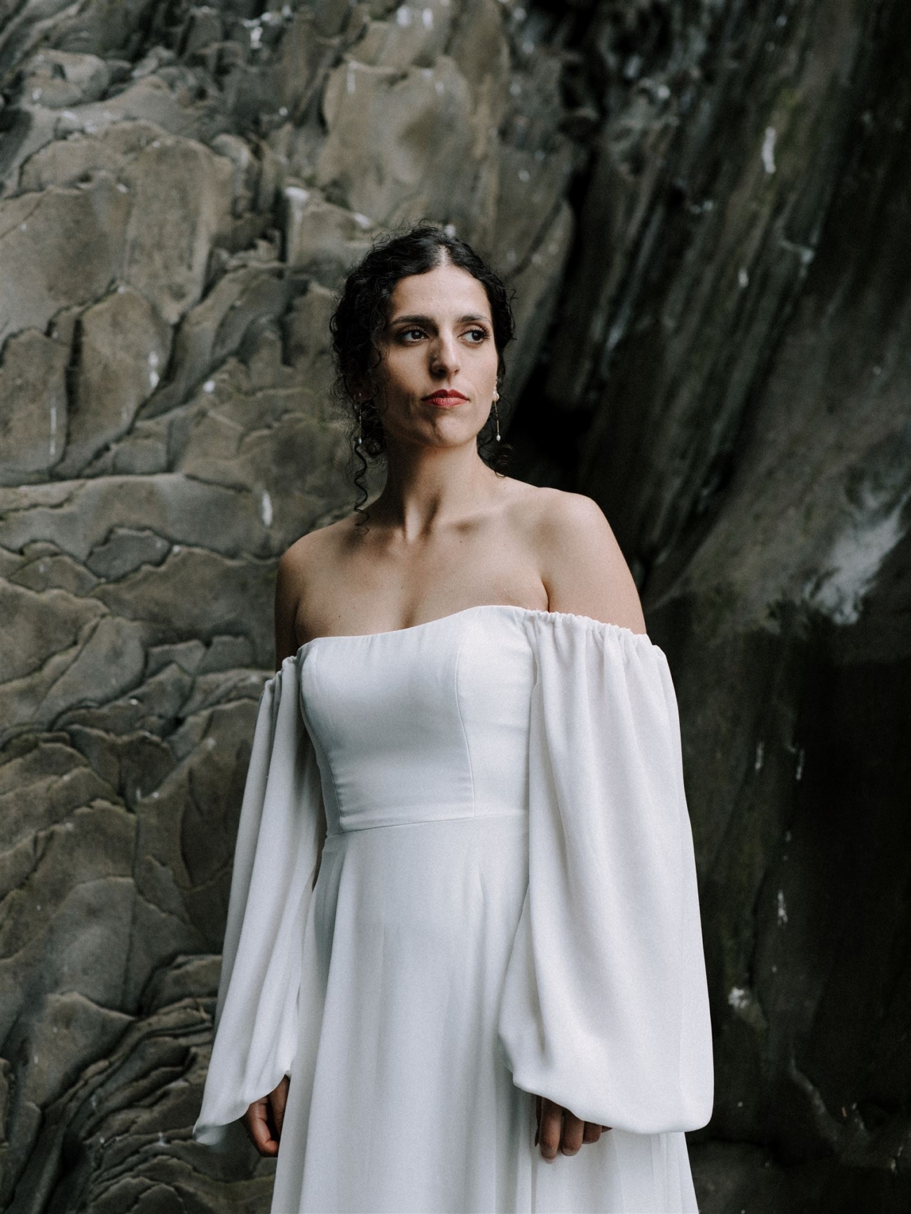 A bridal portrait with a basalt cathedral behind her.