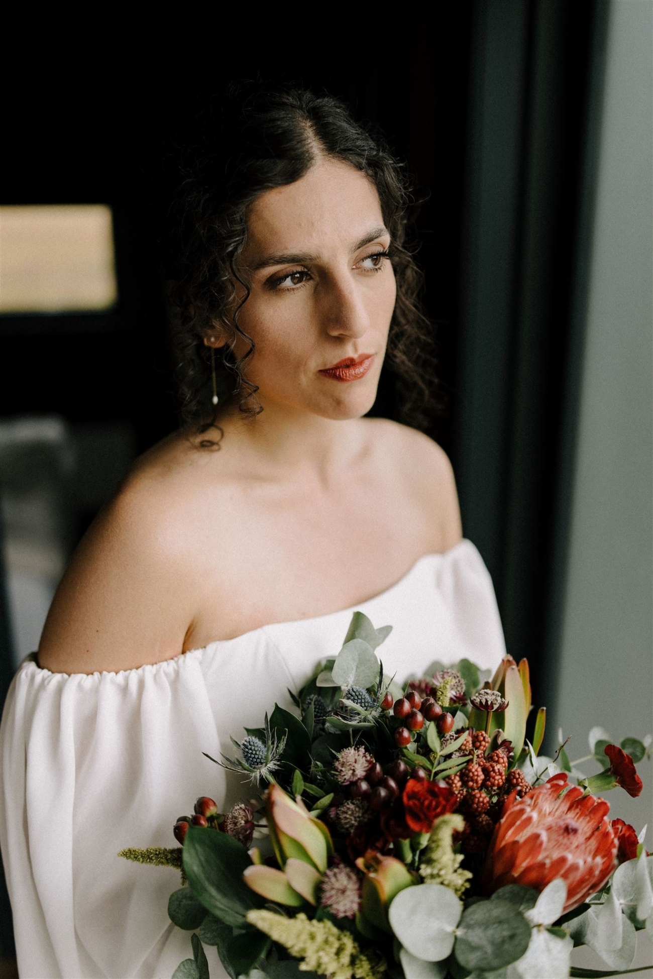 A bridal portrait with a bouquet before heading out into the wild and the weather of Iceland.