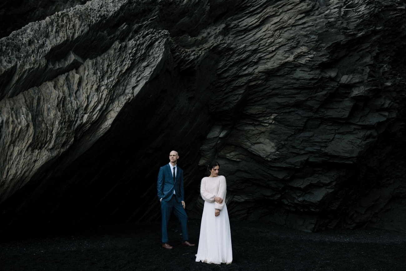 Dark and moody. Looming basalt cliffs and a wedding couple underneath.