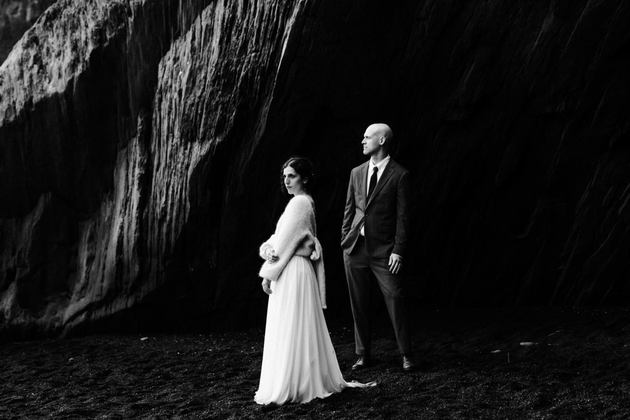 Dark and moody. Looming basalt cliffs and a wedding couple underneath.