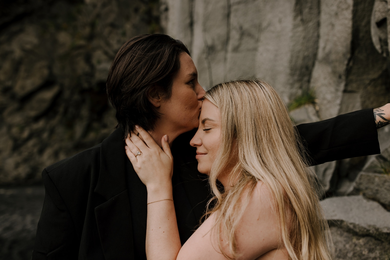 An intimate close up of a forehead kiss.