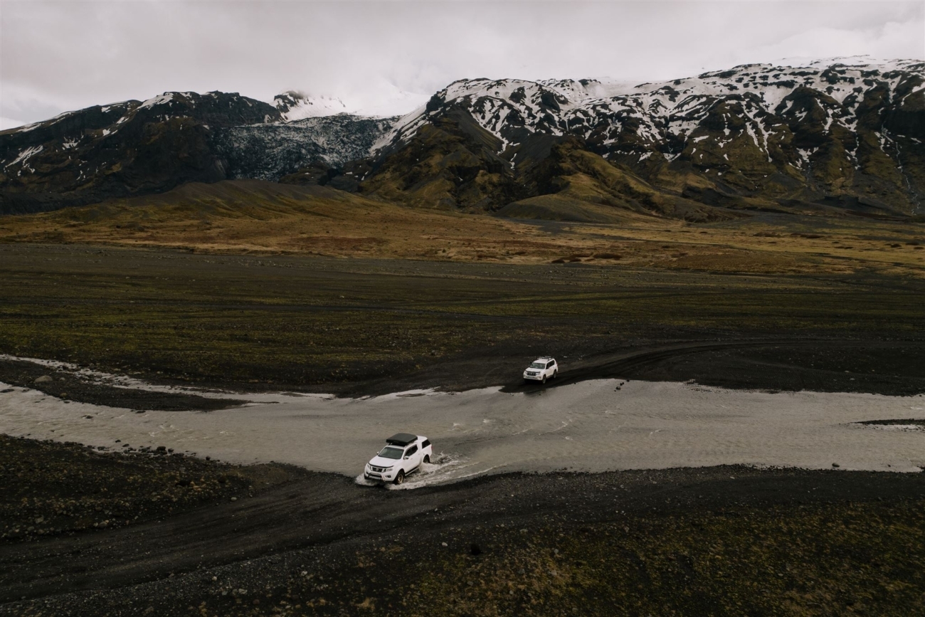 Trucks crossing one of the many rivers required to get to Thorsmork in the highlands of Iceland.