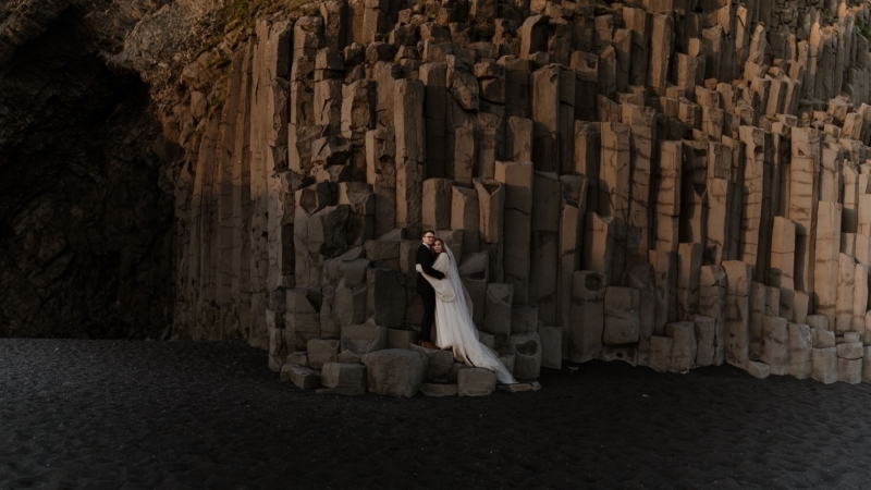The basalt columns on the black sand beach eliminated by the midnight sun.