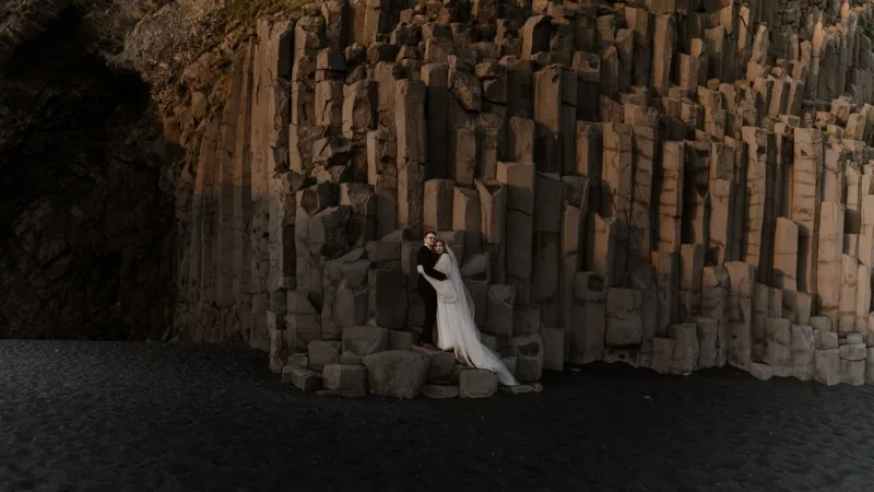 The basalt columns on the black sand beach eliminated by the midnight sun.