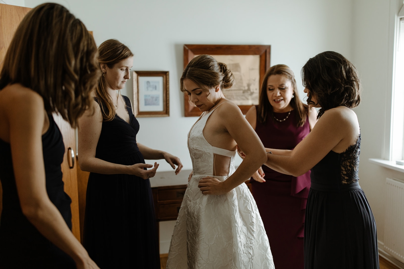 bride getting ready wearing a wedding dress for elopement
