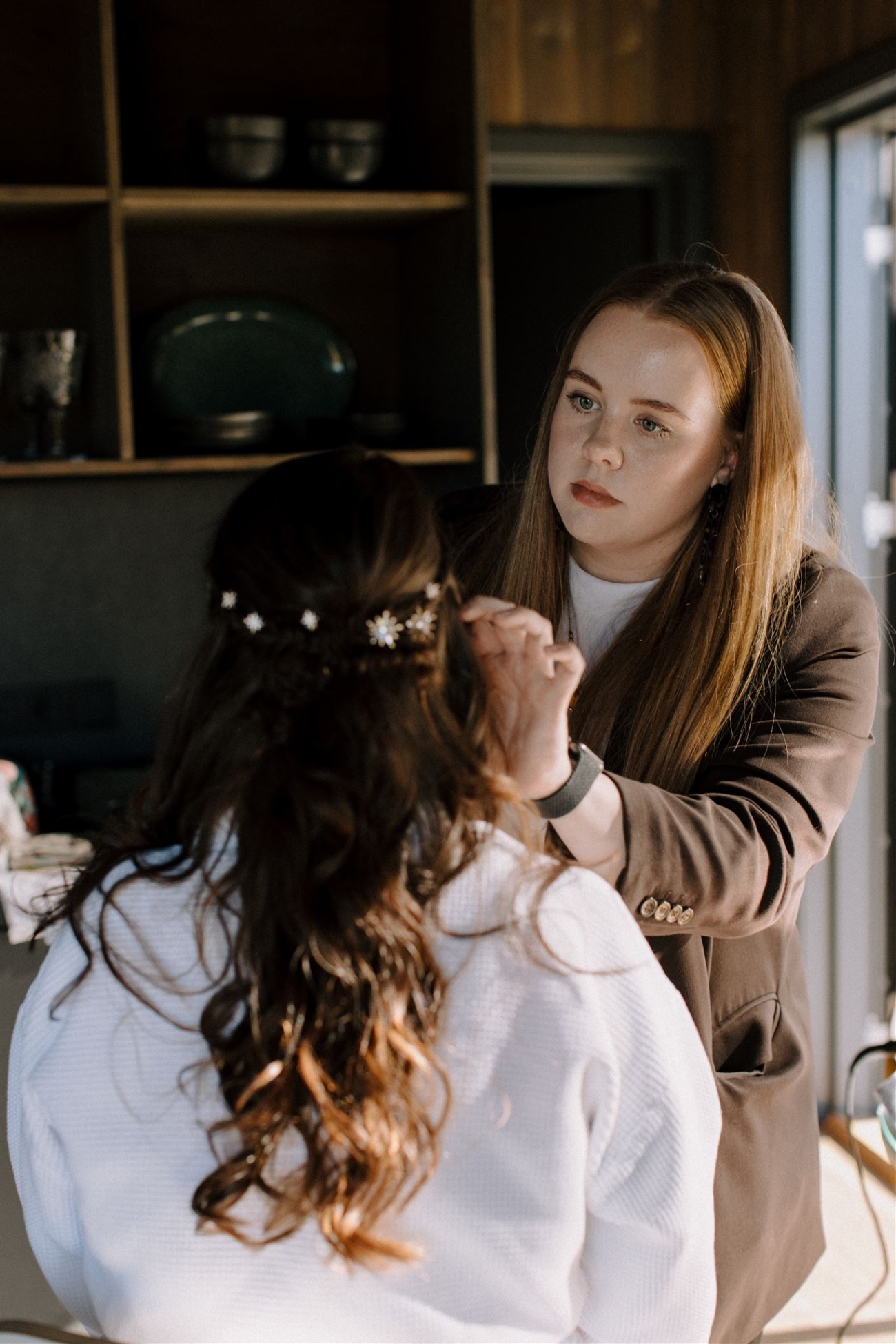 A hair & make up artist works her magic on a bride before her elopement ceremony in the mountains.