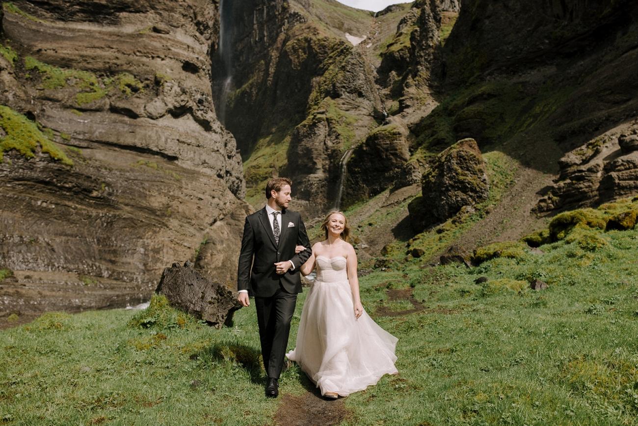 Couple strolling in a green valley at the height of summer in Iceland.