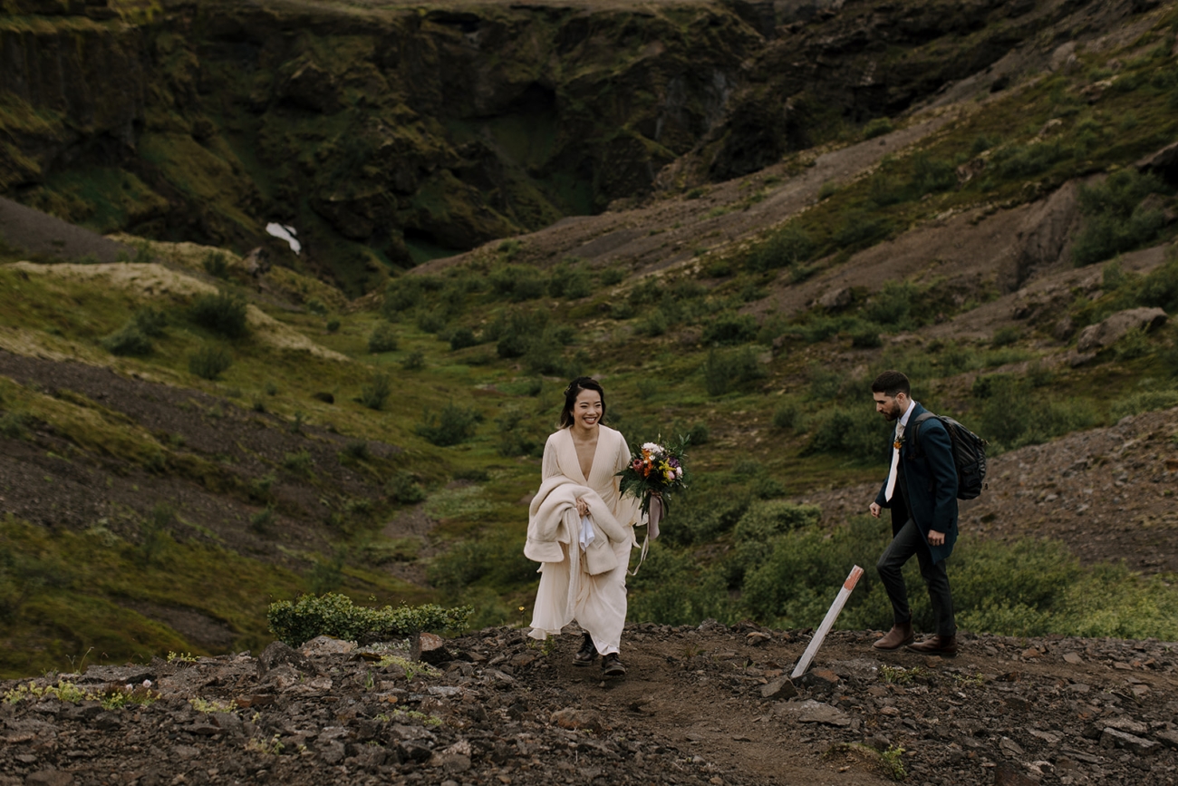 A couple hikes up a mountain in south Iceland's highlands on their way to the ceremony spot on top. 