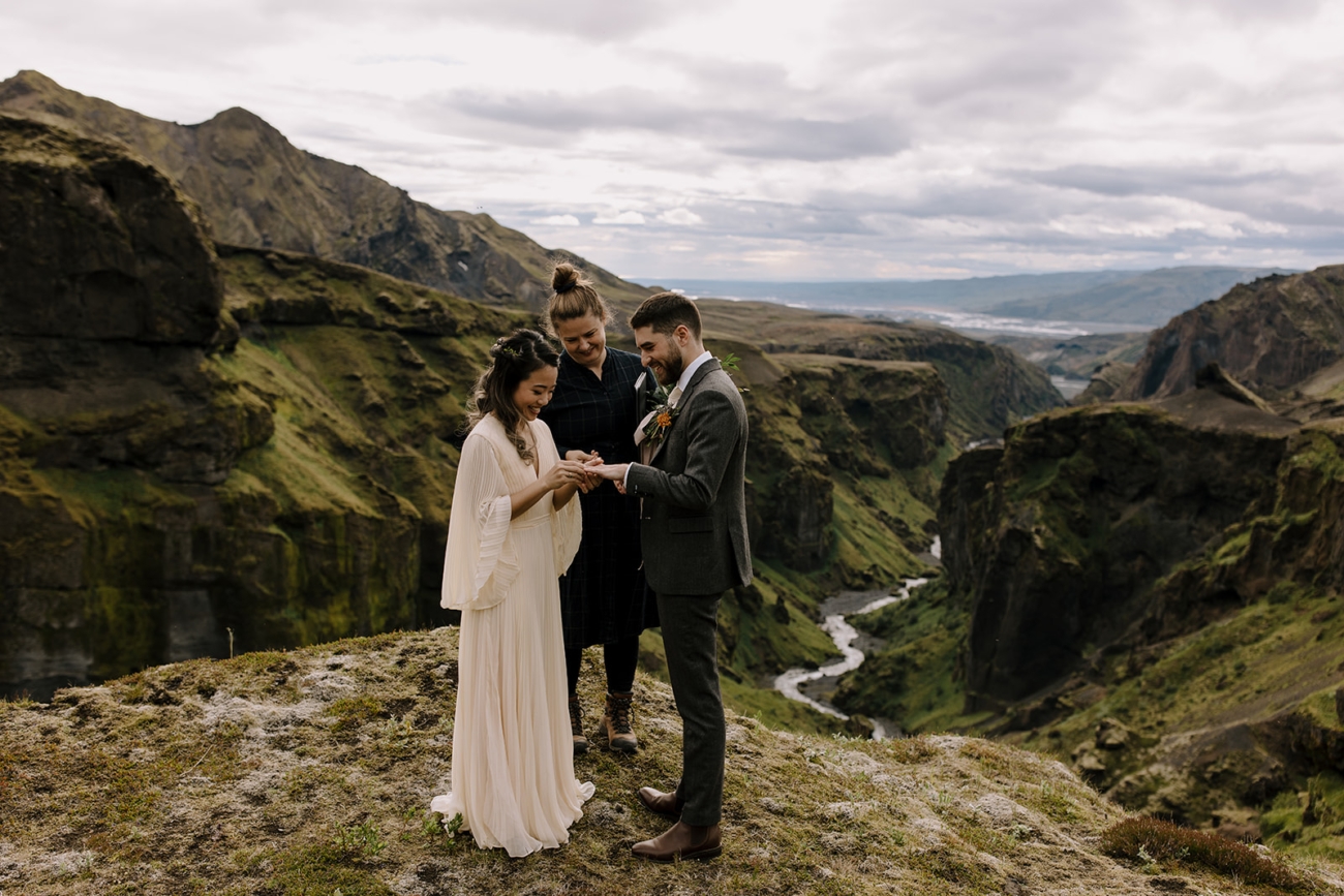 A couple exchanges rings during their adventurous elopement in the mountains.