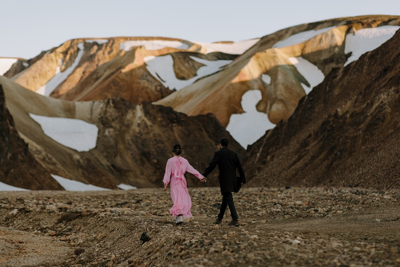 Rhyolite mountains still covered in snow in golden midnight sun light. 