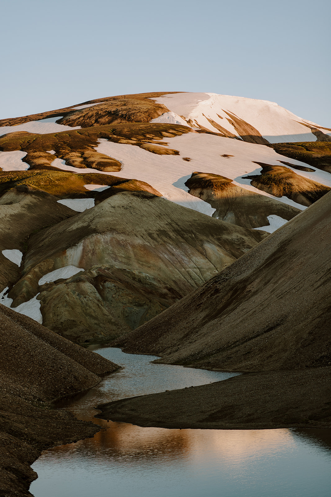 A Rhyolite mountain still holding on to last winters snow in the middle of summer. 