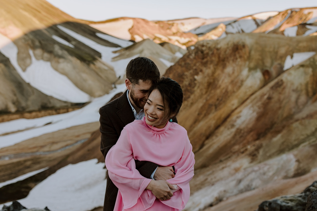 Showcasing intimate moments in vast, rough landscapes. 