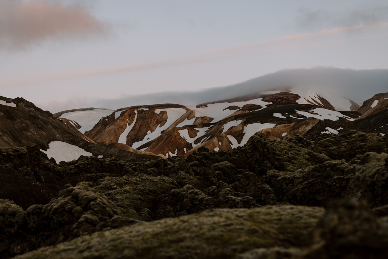 Mist covered Rhyolite mountains in fading light in Landmannalaugar, Iceland. 