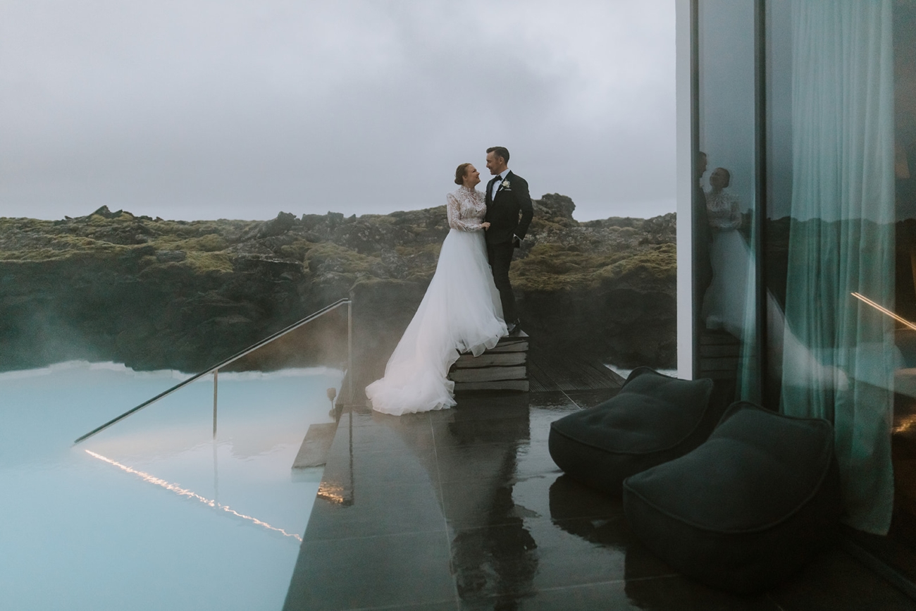Bride and groom photographed by the private lagoon outside their suite at the Blue Lagoon Retreat hotel.