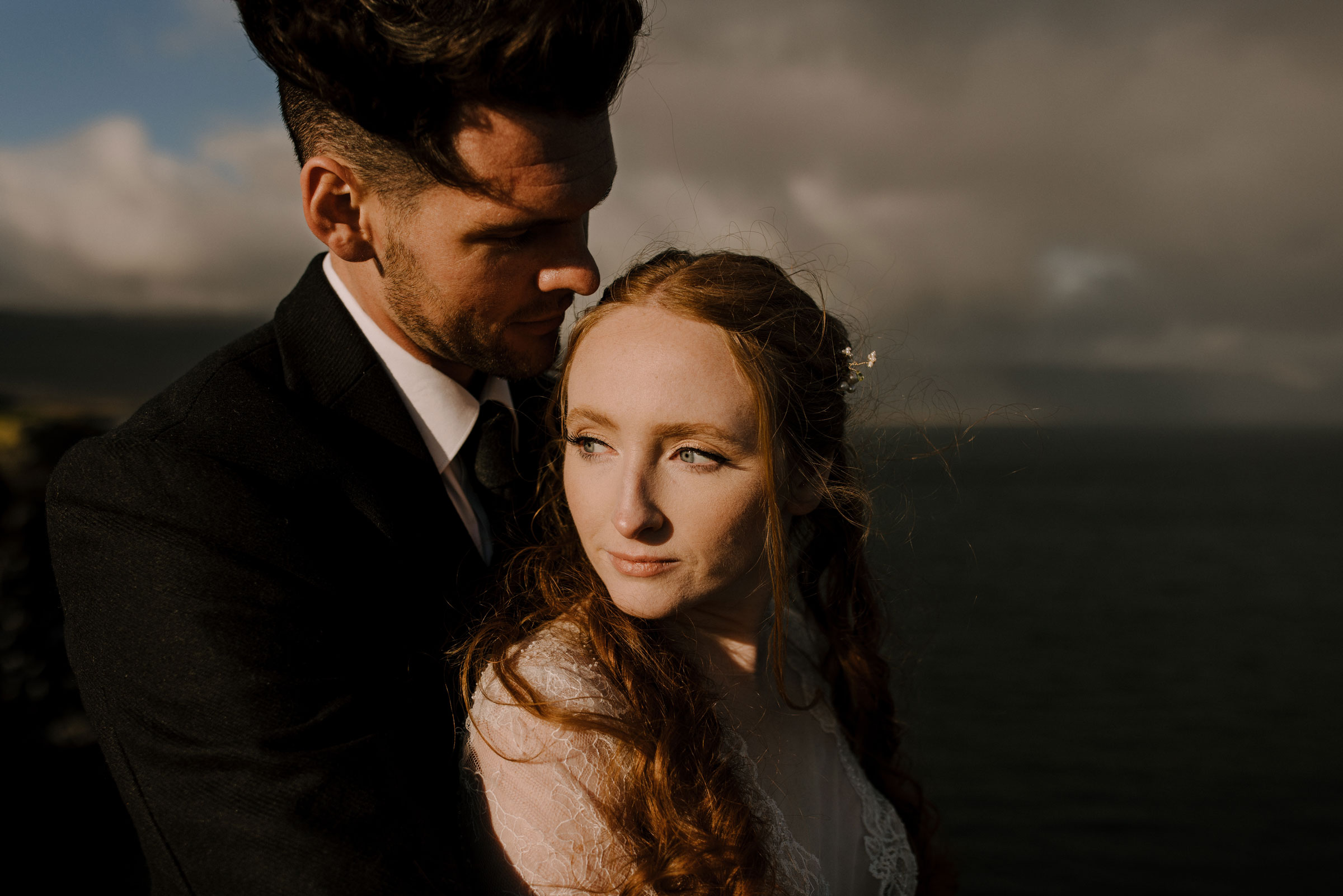 A couple embracing during a moody sunset in Iceland.
